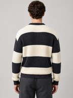 Back view of a black and cream striped knit sweater showing the shoulder line and sleeves