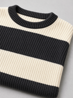 Close up of the ribbed crew neck and wide black and cream stripes on a knit sweater