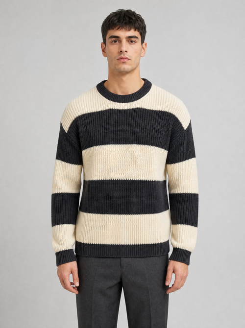 Man wearing a black and cream striped knit sweater, front view on a light grey studio background