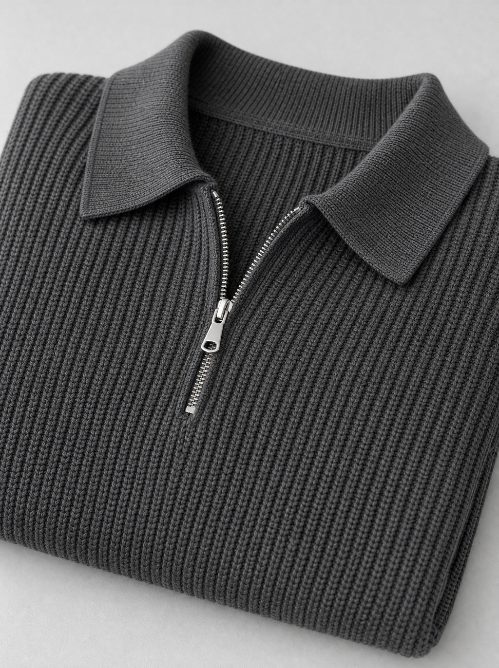 Close up of the collar, zip and knit texture on a charcoal half zip pullover