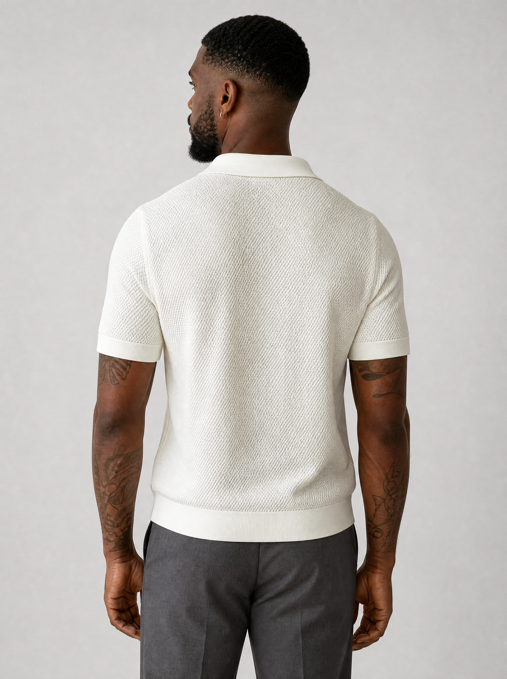 Back view of a cream textured knit short sleeve polo showing the shoulder line and sleeves