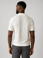 Back view of a cream textured knit short sleeve polo showing the shoulder line and sleeves