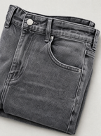 Close up of the waistband, shank button and pocket stitching on frost wash flare leg jeans