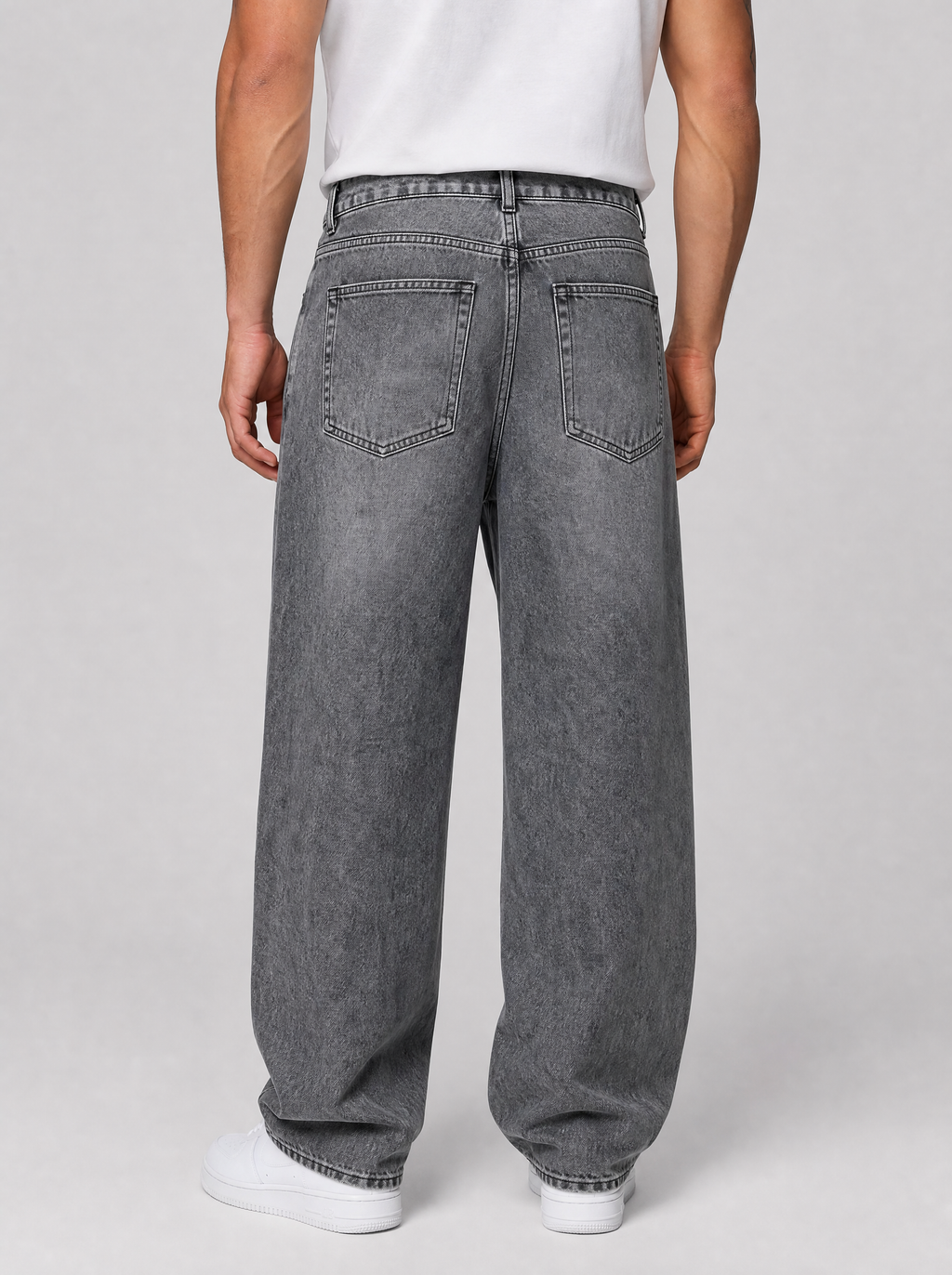 Back view of oversized baggy jeans in washed denim showing the back pockets and yoke