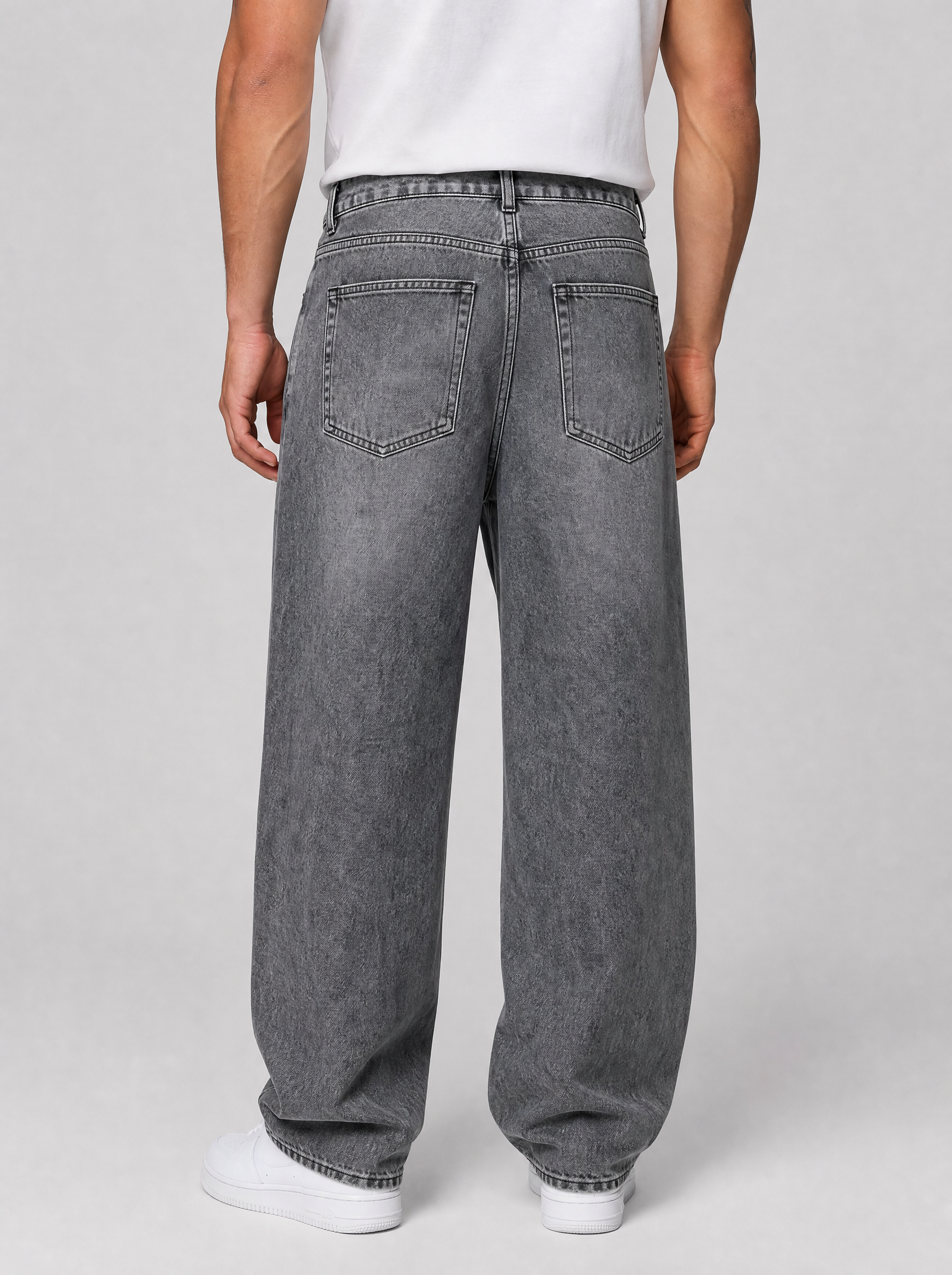 Back view of oversized baggy jeans in washed denim showing the back pockets and yoke