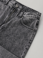 Close up of the waistband, shank button and pocket stitching on smoke grey washed jeans