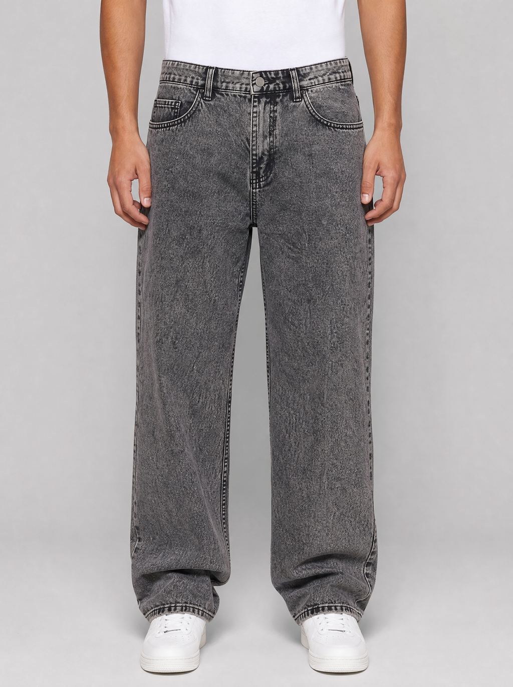 Man wearing smoke grey washed relaxed straight jeans, front view on a light grey studio background