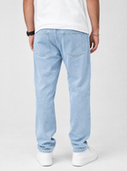 Back view of stretch denim regular fit jeans showing the back pockets and yoke