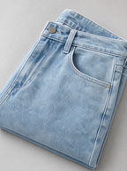 Close up of the waistband, shank button and pocket stitching on stretch denim regular fit jeans