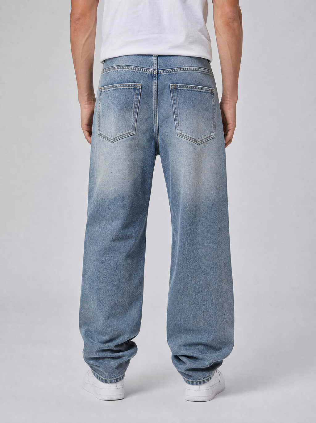 Back view of vintage blue washed straight leg jeans showing the back pockets and yoke