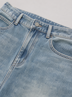 Close up of the waistband, shank button and pocket stitching on vintage blue washed jeans