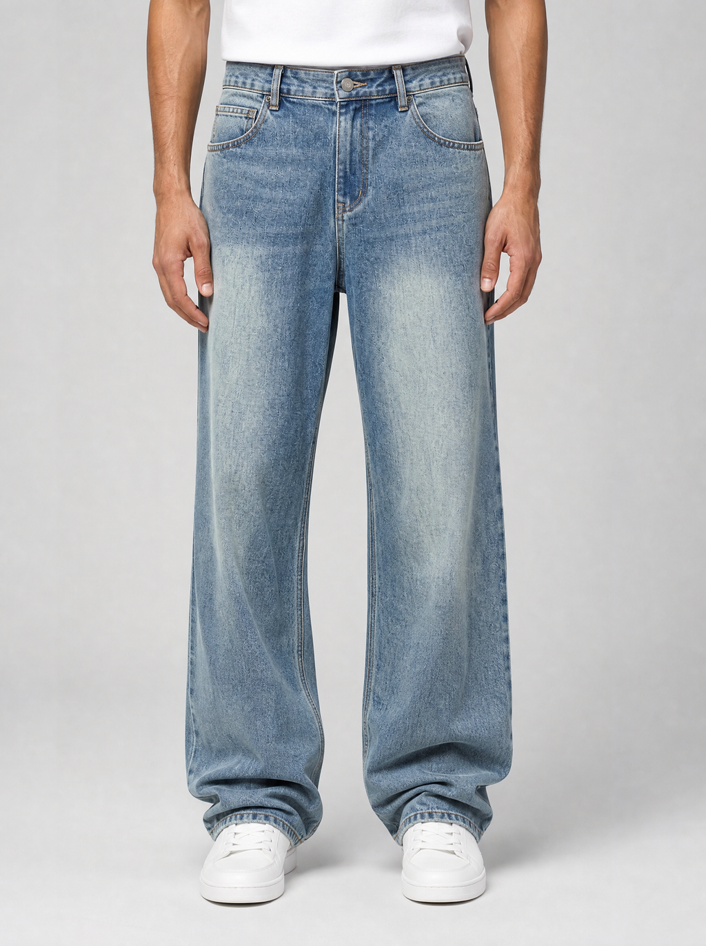 Man wearing vintage blue washed straight leg jeans, front view on a light grey studio background