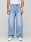 Man wearing washed denim relaxed straight jeans, front view on a light grey studio background