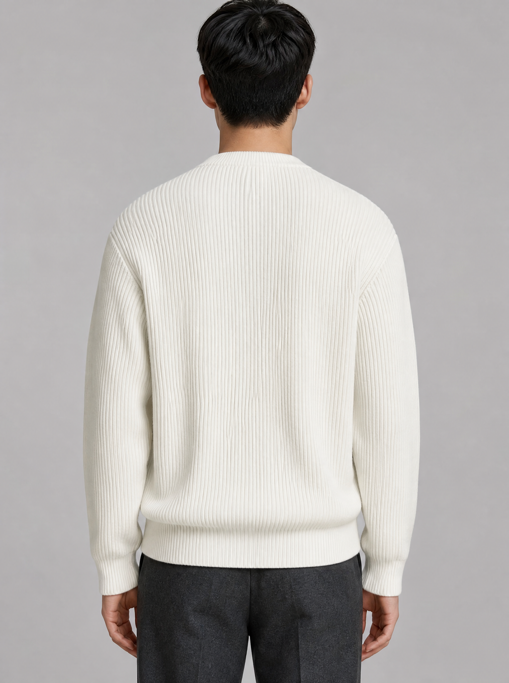 Back view of a white ribbed knit crewneck sweater showing the shoulder line and sleeves