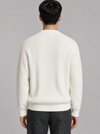 Back view of a white ribbed knit crewneck sweater showing the shoulder line and sleeves